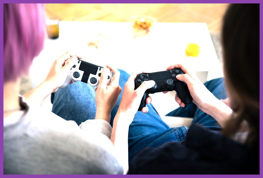 Two gamers playing PC games together in the same home